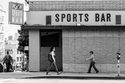 Side view of woman walking on sidewalk