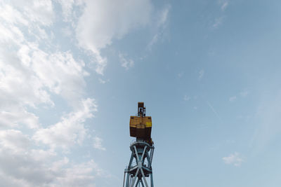 Low angle view of communications tower against sky