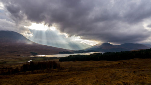 Scenic view of mountains against cloudy sky