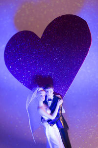 Full length portrait of a young woman against blue background