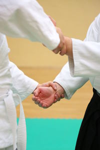 Man with trainer practicing aikido