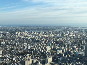 High angle view of city against cloudy sky