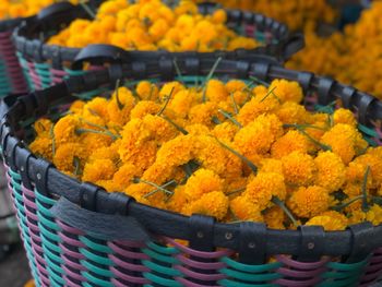Close-up of marigold flowers in basket for sale