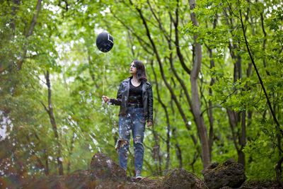 Full length of man standing in forest