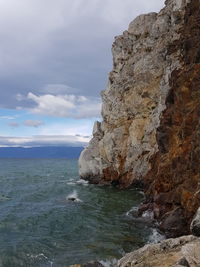Rock formation on sea against sky