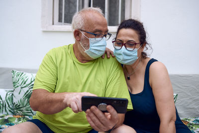 Man and woman using mobile phone