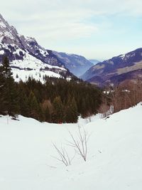 Scenic view of snowcapped mountains against sky