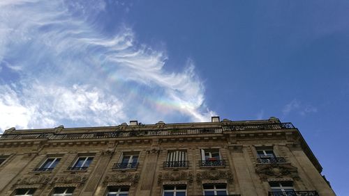 Low angle view of building against cloudy sky