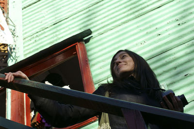 Low angle view of woman against building