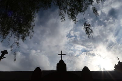 Low angle view of silhouette temple against sky