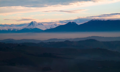 Scenic view of silhouette mountains against sky during sunset