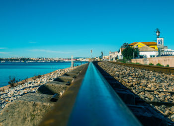 Surface level of railroad tracks against blue sky