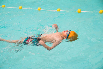 High angle view of woman swimming in sea