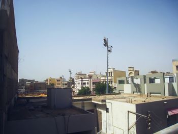Buildings in city against blue sky
