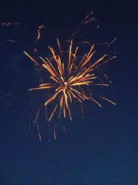 Low angle view of firework display at night