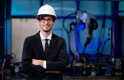 Portrait of businessman standing in gym