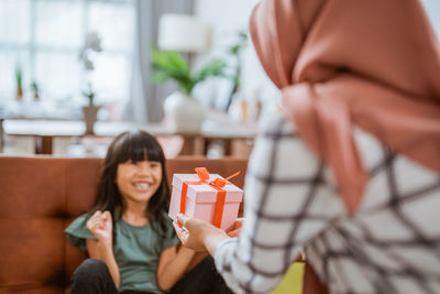 Portrait of woman holding gift