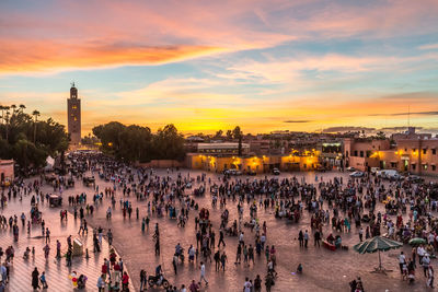 High angle view of crowd in city at sunset