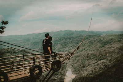 Couple looking at landscape from observation point