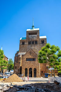 Low angle view of building against clear blue sky