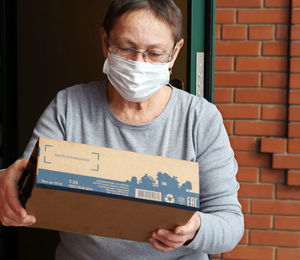 Close-up portrait of a man holding box