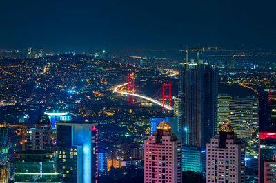 High angle view of city lit up at night