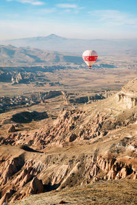 Aerial view of hot air balloon flying over landscape