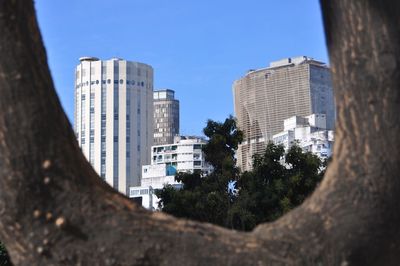 Low angle view of modern buildings against clear blue sky