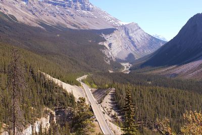 Panoramic shot of road by mountains against sky