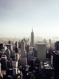 Aerial view of buildings in city against sky