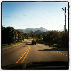 Country road leading towards mountains