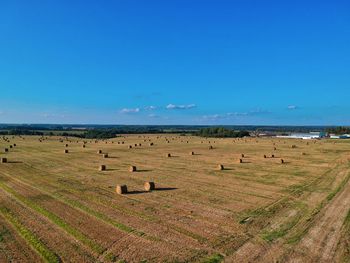 Scenic view of field against blue sky