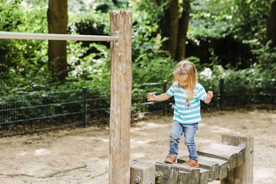 Full length of girl standing boy standing at playground