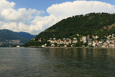 Town by sea against sky