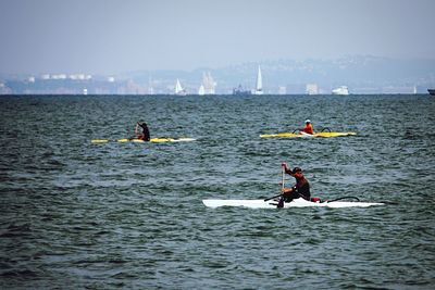 People surfing in sea
