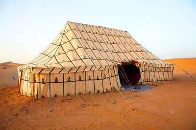 Tent in the desert against clear sky