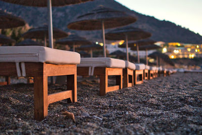 Empty chairs and tables at beach