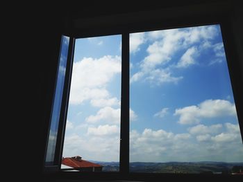 Cloudy sky seen through glass window