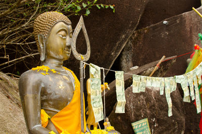 Buddha statue with bank notes at khao khitchakut national park