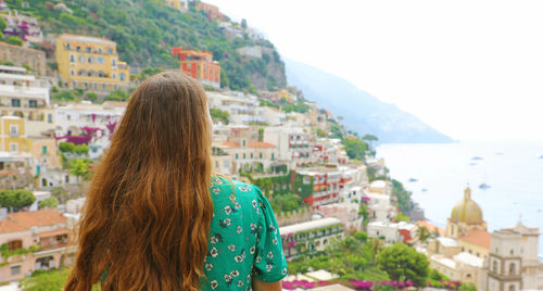 Rear view of woman looking at city buildings