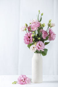 Midsection of bride holding bouquet