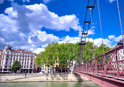 Bridge over river against cloudy sky