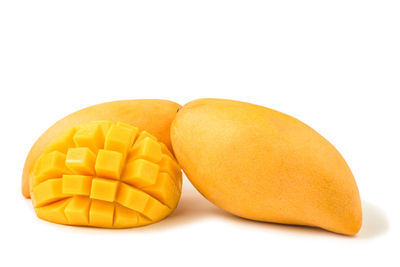 Close-up of yellow eggs against white background
