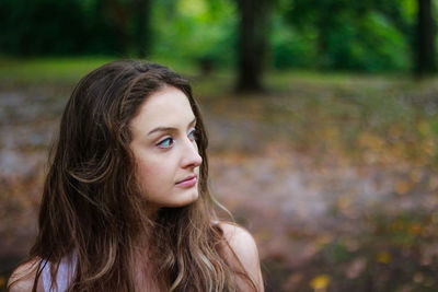 Close-up of beautiful young woman looking away