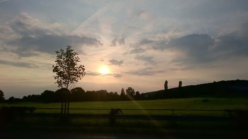 Scenic view of field against sky during sunset