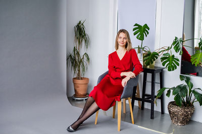 Low section of woman sitting on sofa at home