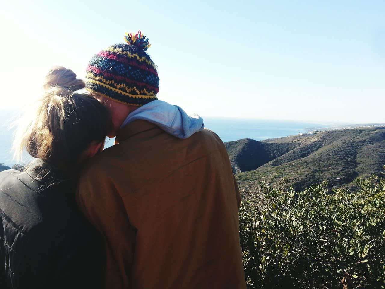 rear view, lifestyles, clear sky, leisure activity, person, casual clothing, standing, men, copy space, nature, beauty in nature, tranquility, sky, looking at view, waist up, three quarter length, tranquil scene, scenics