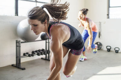 Female athletes running in gym