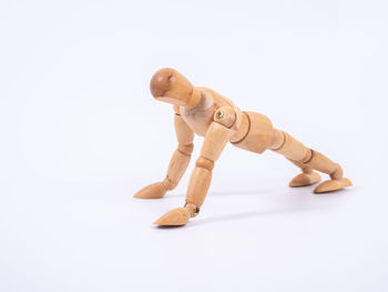 Close-up of broken toy against white background