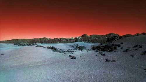 Scenic view of landscape against clear sky during sunset